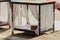 One open gazebo with curtains pillow and bedding on the sand