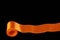 One orange horizontal ribbon isolated on black