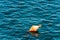 One orange mooring buoy in the sea - Italy