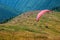 One paraglider flies over a mountain valley in summer sunny day in the Carpathians in Ukraine.