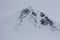 One of the peaks of the Caucasus mountains during a snowfall.