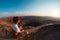 One person looking at the Fish River Canyon, scenic travel destination in Southern Namibia. Expansive view at sunset. Wanderlust t