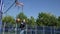 One Person Playing Basketball for Fun, a Recreational Sports Activity. Man Relaxing Playing Basketball in a Park.