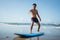 one person practicing surfing during summer vacation on the sand