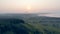 One person sailplanes a glider on a sunset background.