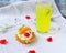 one pie basket of shortbread dough with custard cream and pieces of kiwi and peach fruit, decorated with a cherry with lemonade.