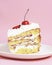 One piece of vanilla cherry cake on a white plate over pastel pink background. Delicious sweet dessert close up.