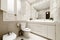 One-piece white porcelain washbasin with two bowls on a white