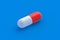 One pill on blue background. Concept of healthcare and medical