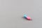 One pill colored in pink and blue with copy space