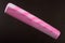 One pink hairbrush on a dark background