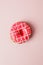 One pink live colar donut with heart shaped sprinkles on pink background, monochrome seet unhealthy food, love, valentine day