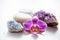 One pink orchid blossom with zen stones and amethyst cluster and blue cluster crystal.
