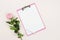 One pink rose flower and clipboard mock up for text. Festive minimal background.