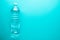 One plastic clean water bottle on neo mint background