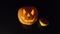 One pumpkin on Halloween with a sinister expression on a black background