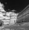 One of the ramparts of the ancient Rocca di San Leo, Rimini, Italy, in black and white against a dramatic sky