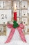 One red advent candle with a red checkered bow for christmas