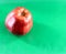 One red Apple fresh with water drops on green background