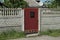One red closed metal door with a black mailbox