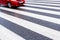 One red, fast, dangerous blurred car on the crosswalk, no people, wet asphalt, empty space