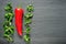 One red Kapia pepper with valeriana salad on a dark shale