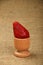 One red mellow strawberry in eggcup on canvas