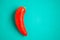One red pepper on the turquois background