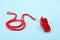 One red whistle with cord on blue background