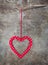 One red and white dotted heart decoration on wooden background