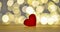 One red wooden hearts on bokeh background