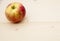 One ripe bright Apple on a wooden background