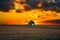 One rural barn in the middle of field landscape on the sunset and the stormy sky