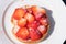 One rusks with strawberries with sugar on a white plate.Seen from above. Selective focus