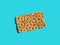 One scandinavian rye whole grain crispbread with sesame seeds on solid blue background. Harsh shadows hard light. Trendy