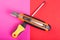 One screwdriver and cutter on pink and red background