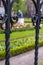 One section of modern steel fence with green fields of tulips