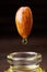 One seed of almond with a drop of oil