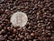 One silver bitcoin closeup on coffee beans background