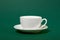 One simple coffee cup on green color background, closeup photo