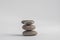 One simplicity stones cairn isolated on white background, group of light three gray white pebbles built in tower