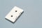 One single retro audio cassette on light grey background, top view