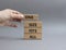One size fits all symbol. Concept words One size fits all on wooden blocks. Beautiful grey background. Businessman hand. Business