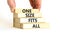 One size fits all symbol. Concept words One size fits all on wooden blocks. Businessman hand. Beautiful white table white