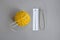One skein of yellow wool yarn, knitting spokes, measuring ruler and large pin on gray background, handmade, knitting. Close-up.