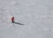 One skier in the slope with snow with red clothing