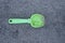 A one small green dirty plastic baby scoop