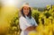 One smiling mature mixed race confident farmer standing with her arms crossed on her vineyard with copyspace. Hispanic