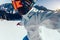 One snowboarder taking selfie while snowboarding