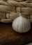 One solo garlic near basket on wooden table close-up